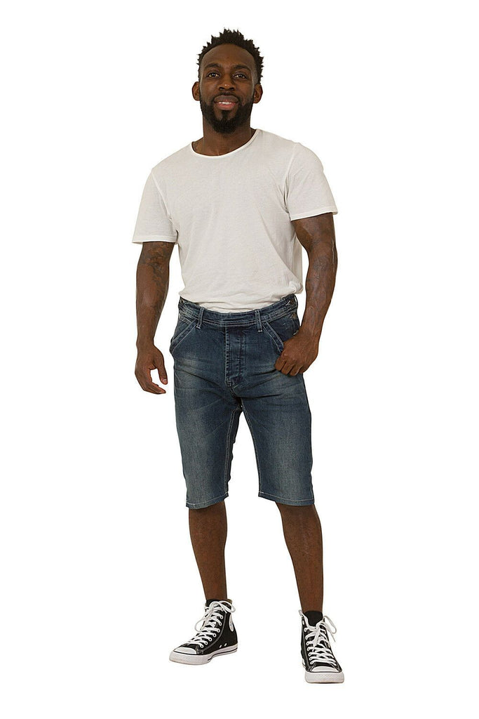 Full forward-facing pose, wearing loose fitting blue denim dungaree shorts with bib removed.