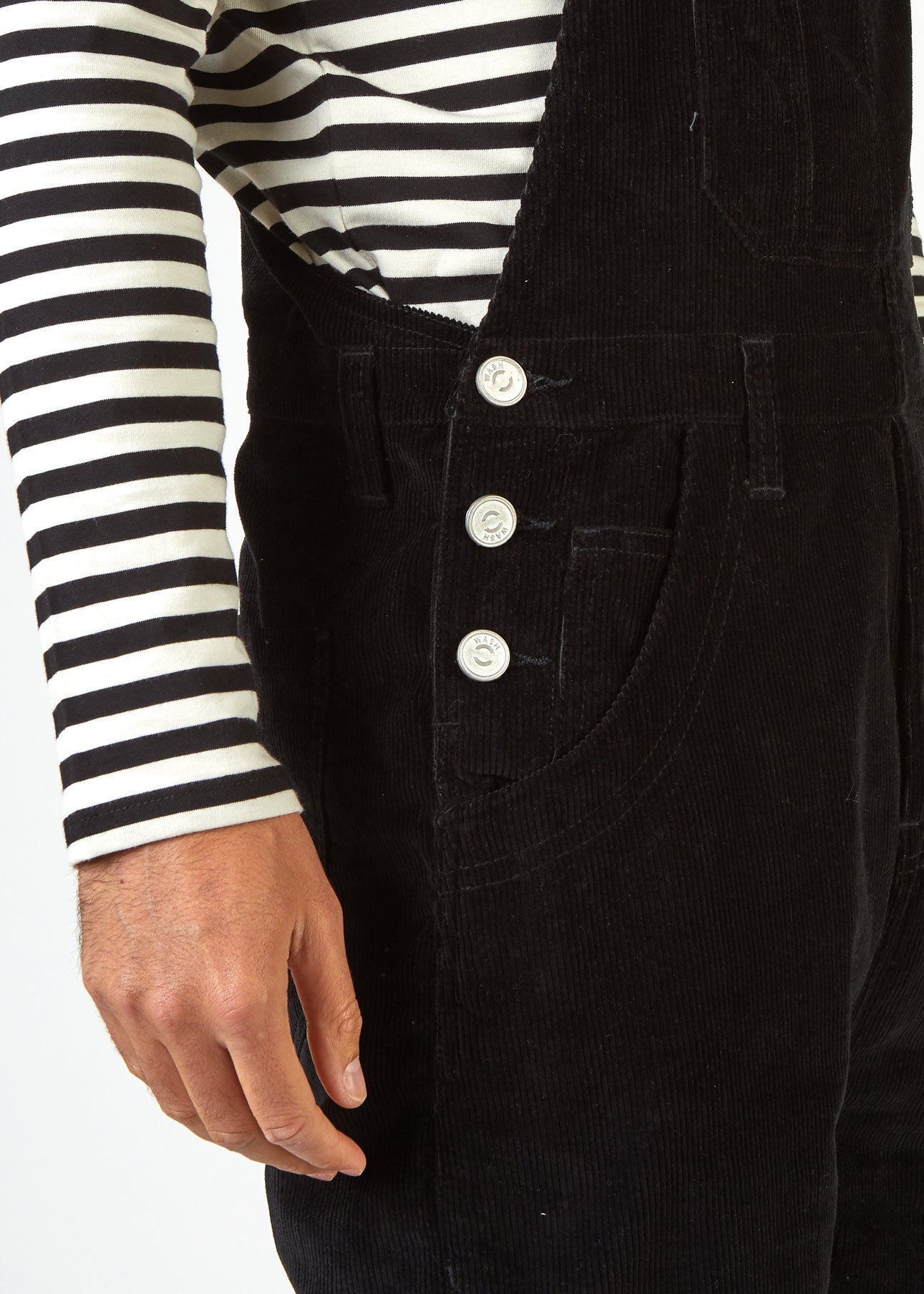 Close up of hip area and 3-button fastening of Bertie black cord dungarees