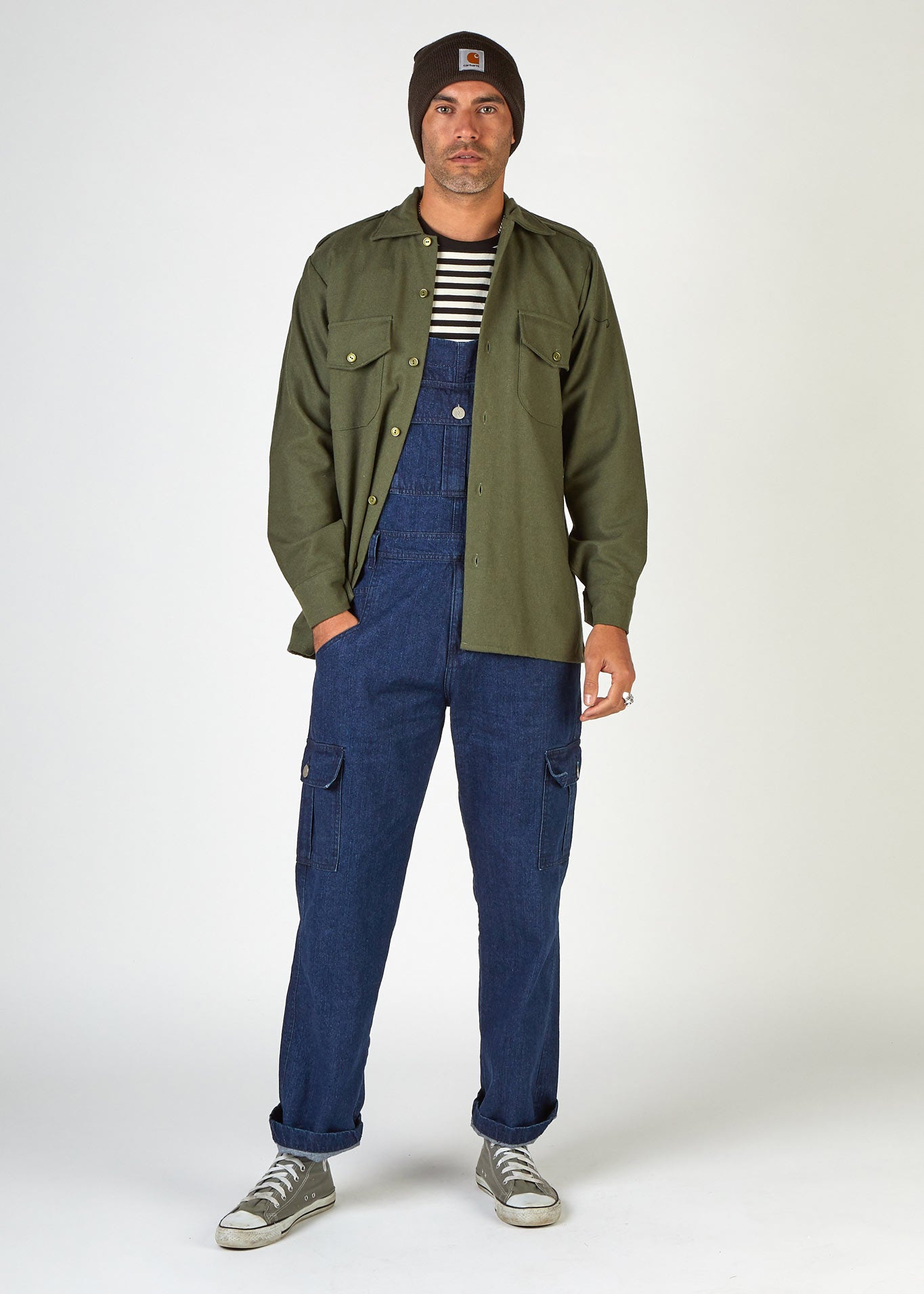 Front view of 90's-style 'Lee' bib-overall paired with green army-style shirt.