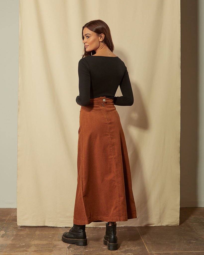 Full-length angled back view of Lottie brown cord maxi-skirt showing back zip.