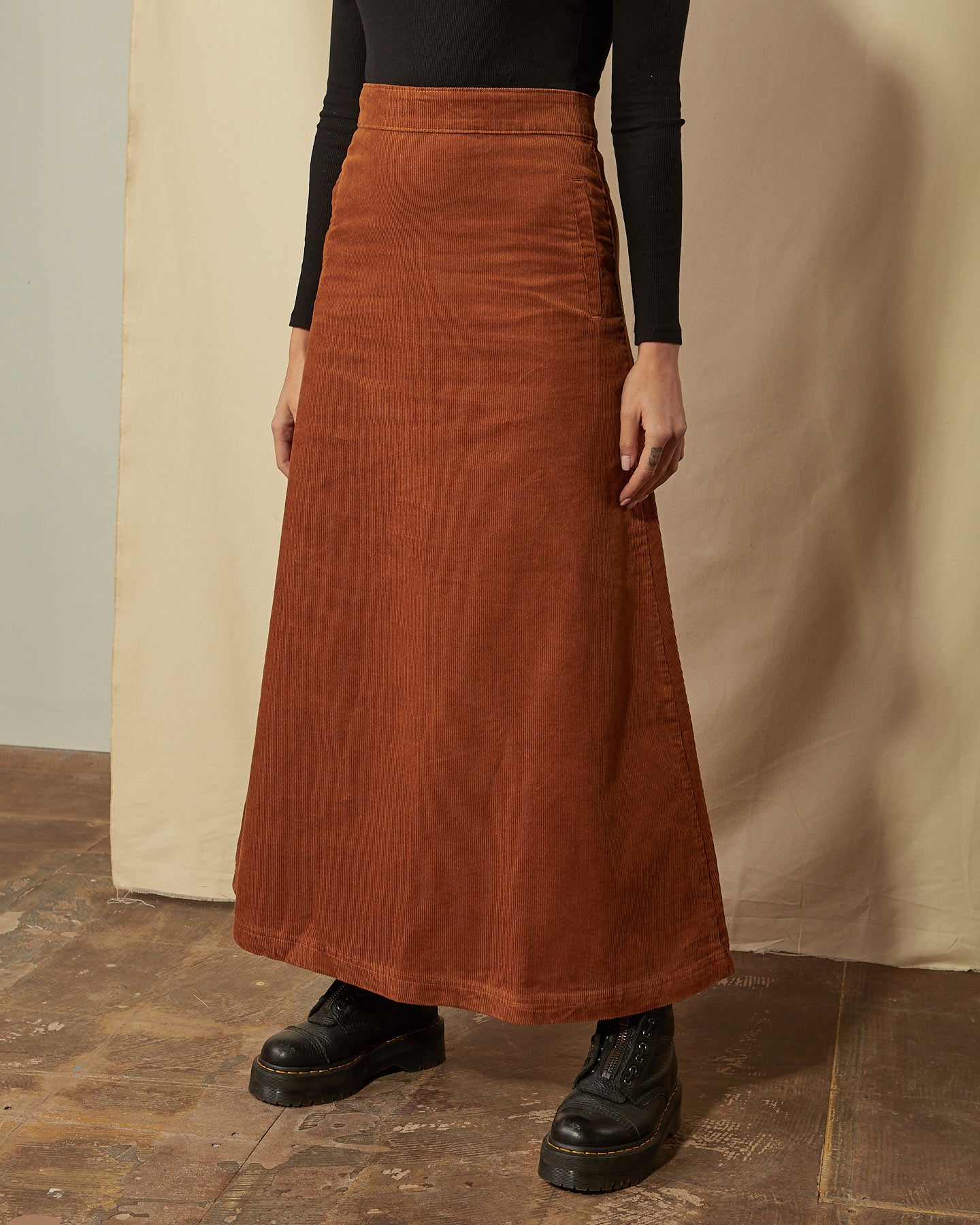 Close-up of Lottie brown corduroy full length skirt with clear view of cord fabric ridges.