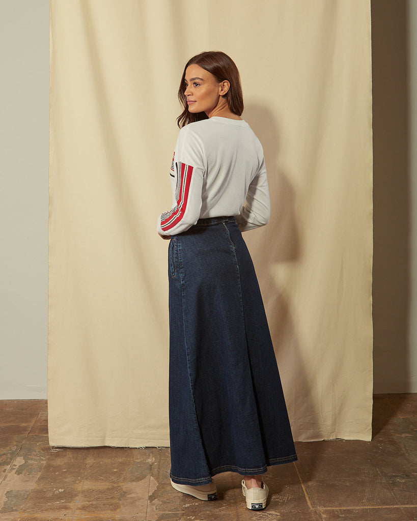 Full-length angled back view of Lottie darkwash denim maxi-skirt showing back zip.