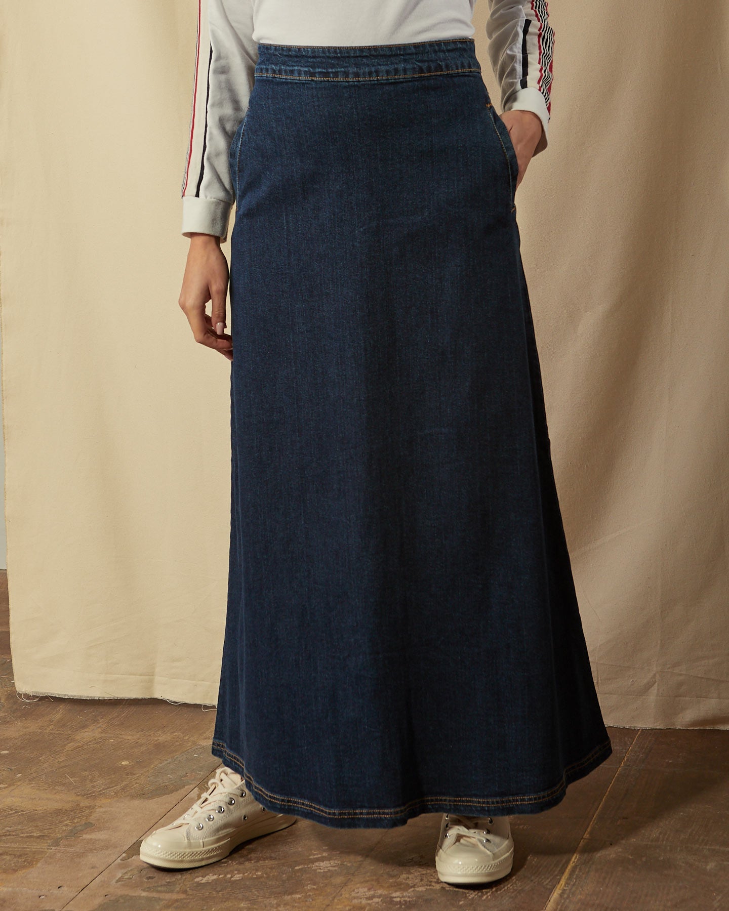 Close-up of Lottie darkwash denim full length skirt with clear view of stitched hem detailing and denim finish.