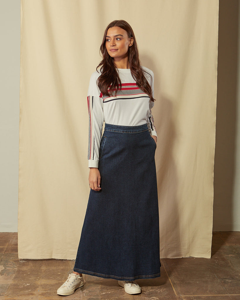 Full-length front view of model wearing Lottie darkwash denim maxi-skirt demonstrating A-line silhouette.