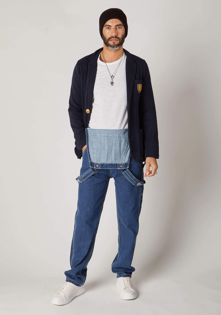 Front view of stonewash dungarees styled with bib-down revealing white t-shirt and bib lining.