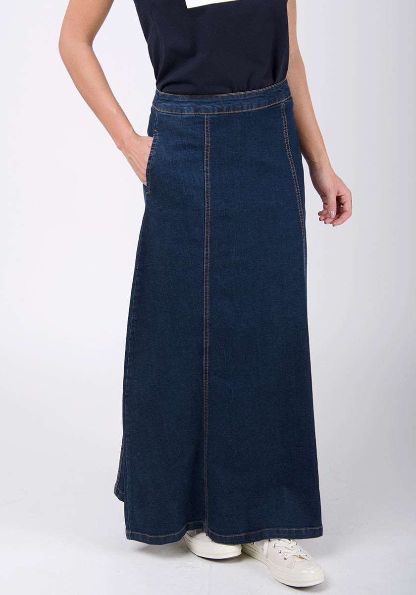 Front close-up view of panelled dark blue denim maxi skirt showing side pocket.