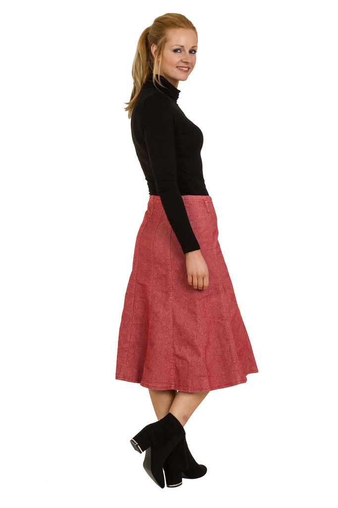 Side model shot of red denim panelled midi skirt showing flared style.