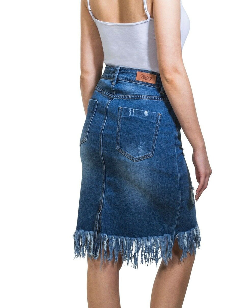 Close-up side view wearing distressed mid-blue denim knee-length skirt with focus on belt loops, back pocket and fringe.