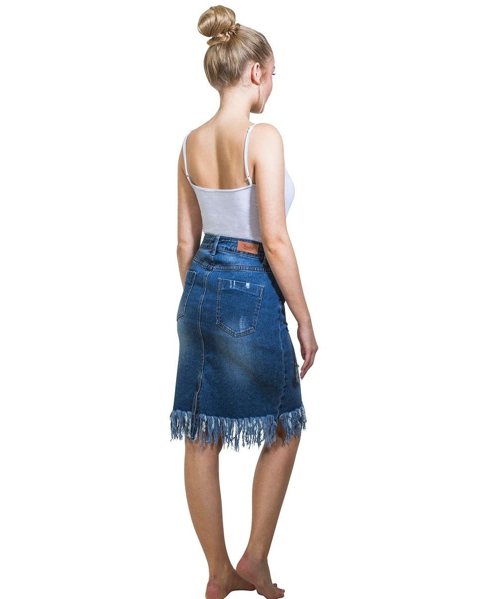 Full-length side-back view wearing distressed mid-blue denim midi skirt, paired with white vest.