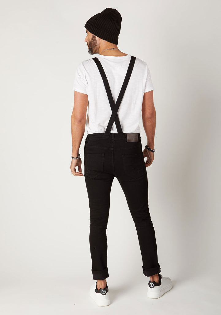 Back shot men's skinny fit black denim bib-overalls showing crossed back straps