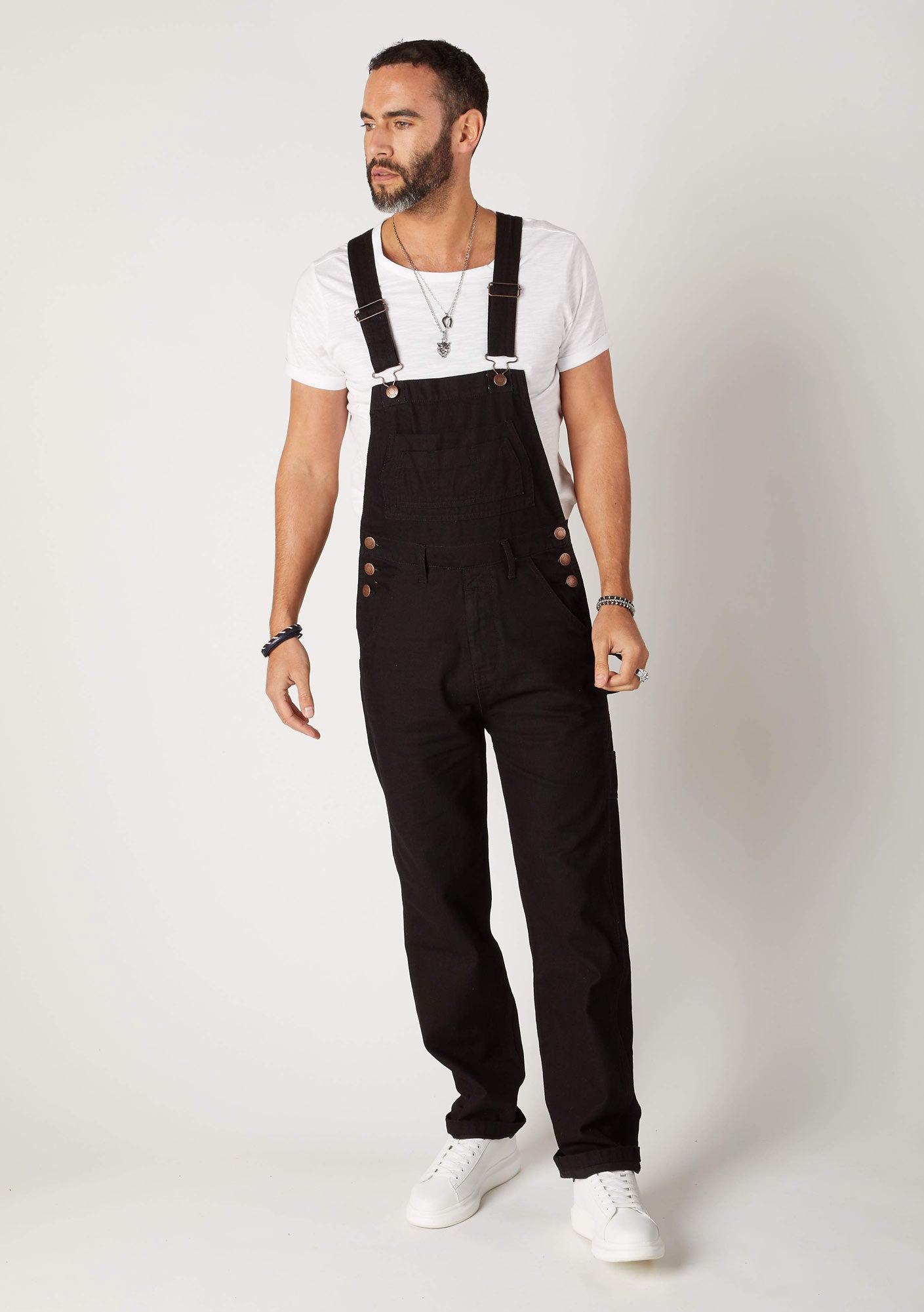 Full-length front walking pose wearing contemporary 'Maddox' dungarees with view of belt loops.