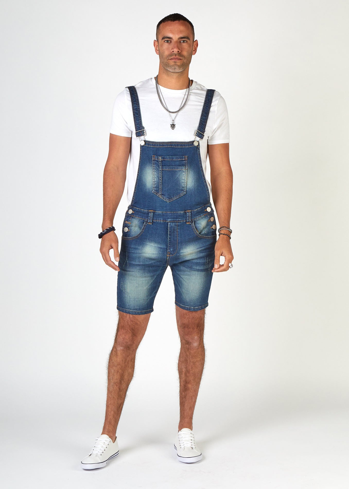 Full-length front view of stylish 'Whitefield' bib-overall super skinny denim dungaree shorts with clear view of pockets and adjustable straps.