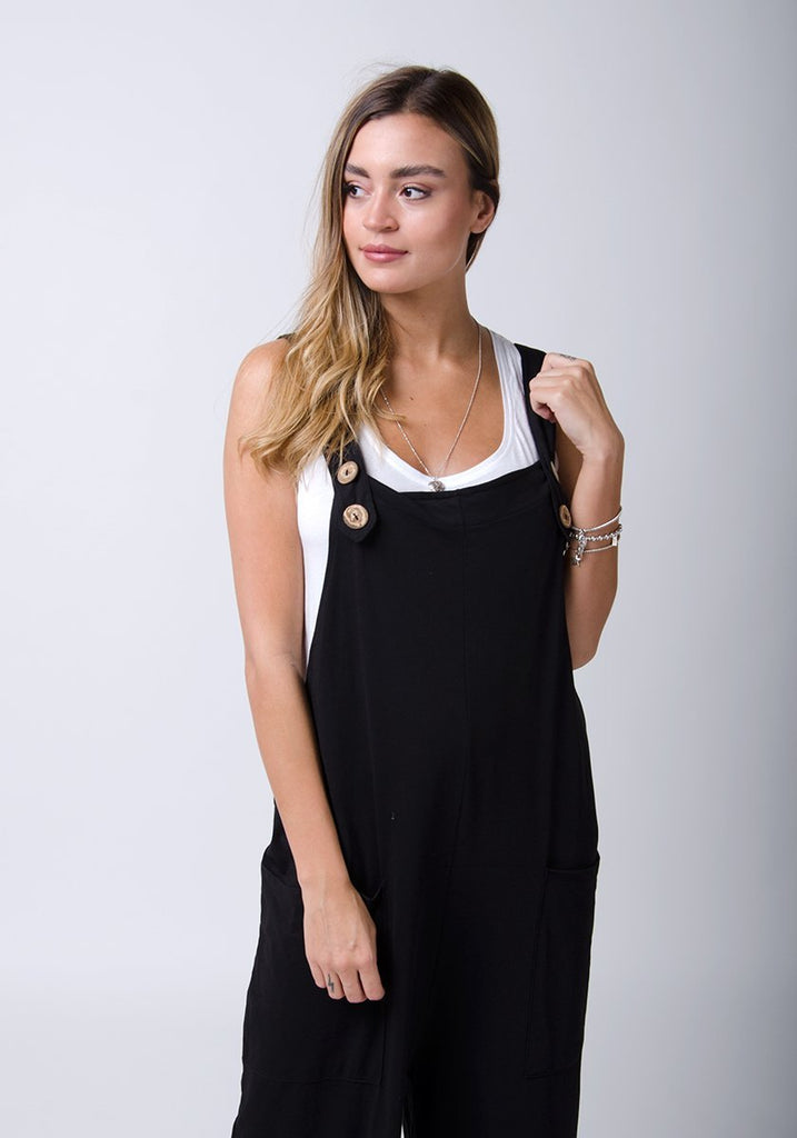 Front half-length pose wearing WASH brand, black, cotton jersey dungarees.