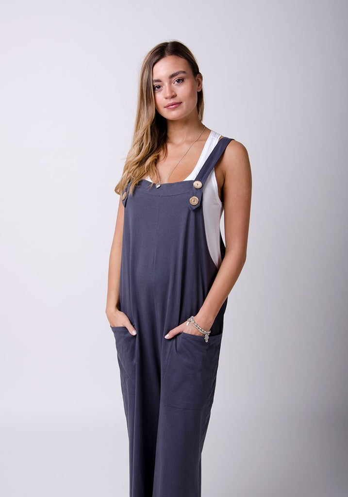 Front two-thirds pose wearing WASH brand, charcoal, cotton jersey overall and highlighting pockets.