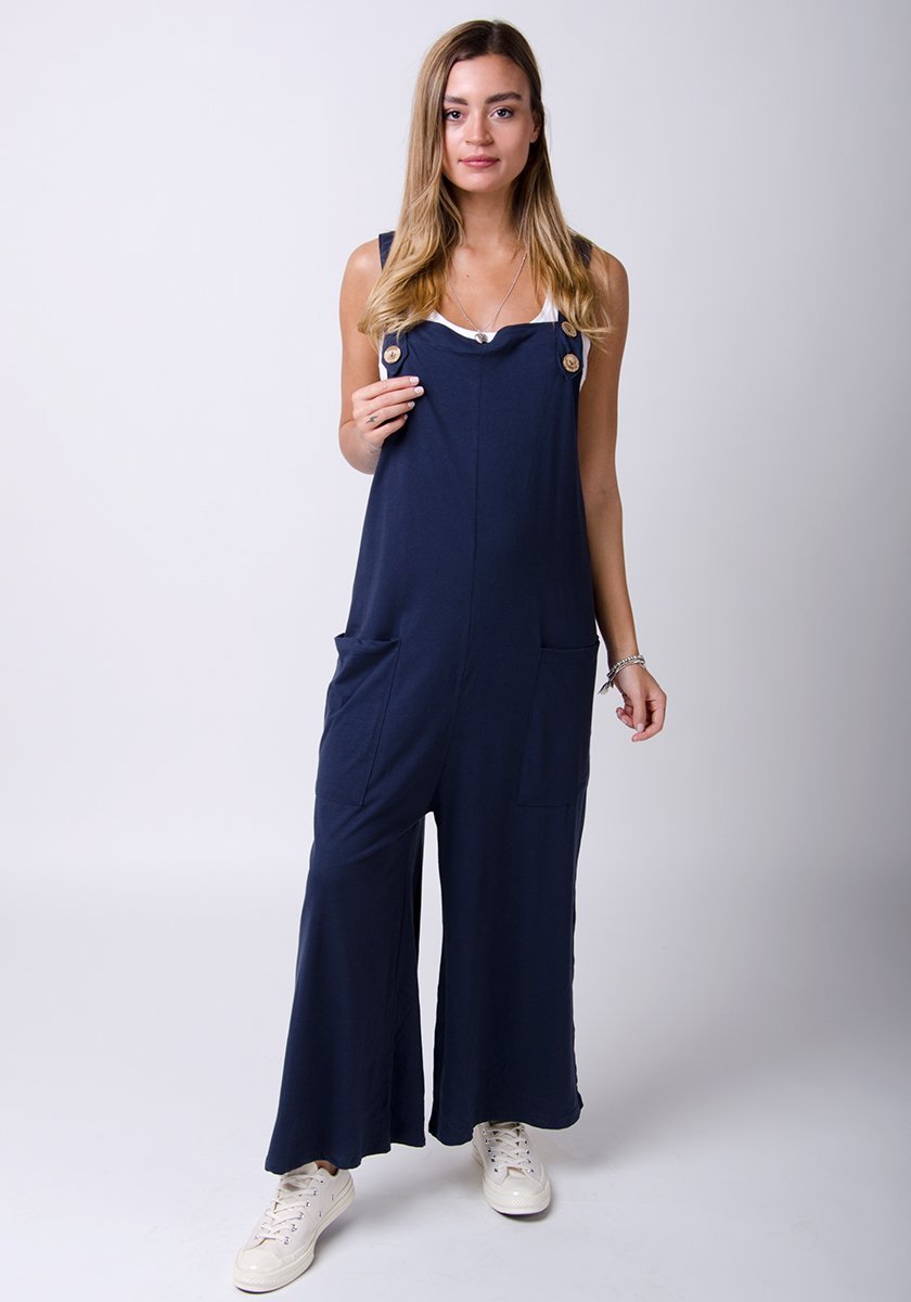 Full-length pose wearing Amber-style, navy cotton jersey, wide-leg overall. Right leg highlighting loose fitting.