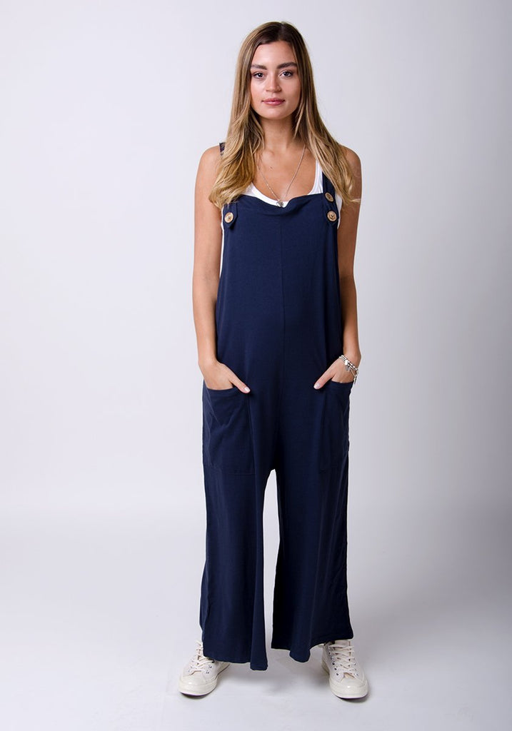 Amber-style, navy-blue cotton jersey, wide-leg overall. Front, full-length pose highlighting functional pockets.