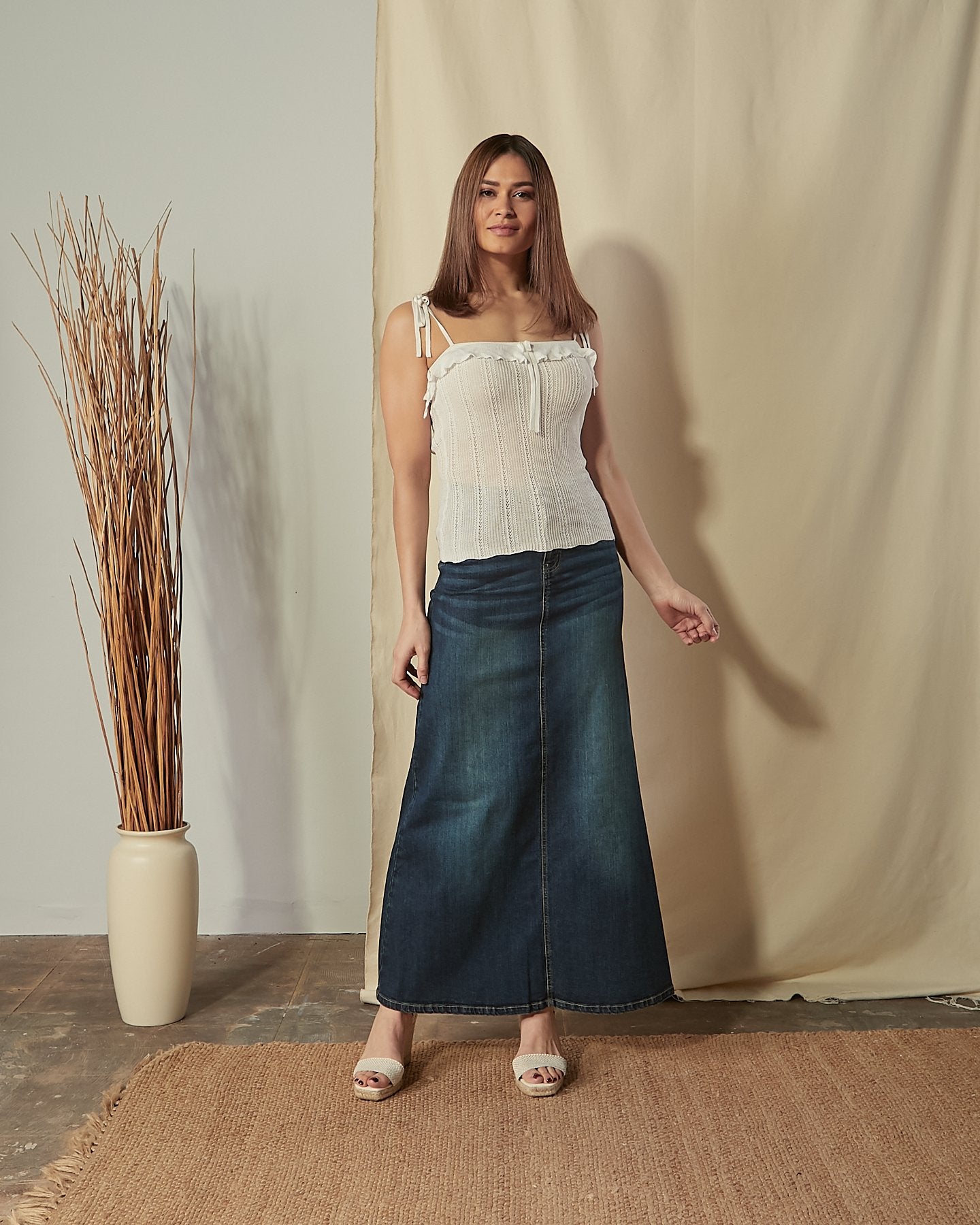 Full-length front view of model wearing vintage-blue Angie organic denim maxi  skirt.