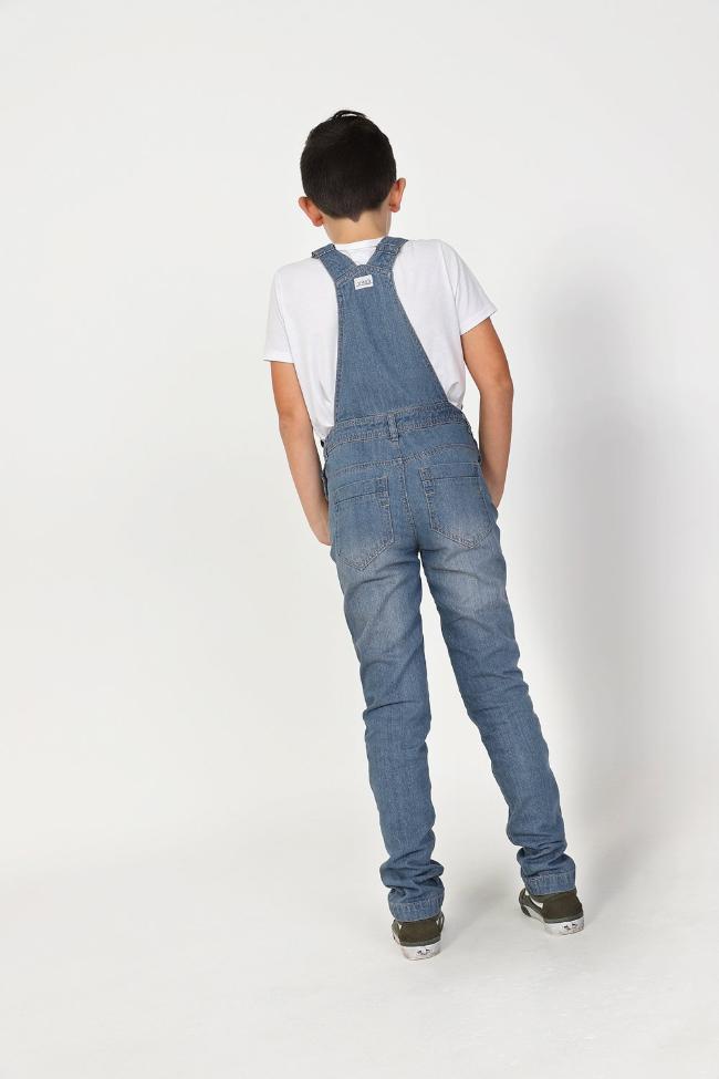 Full rear pose wearing modern style dungarees showing adjustable straps and belt loops.