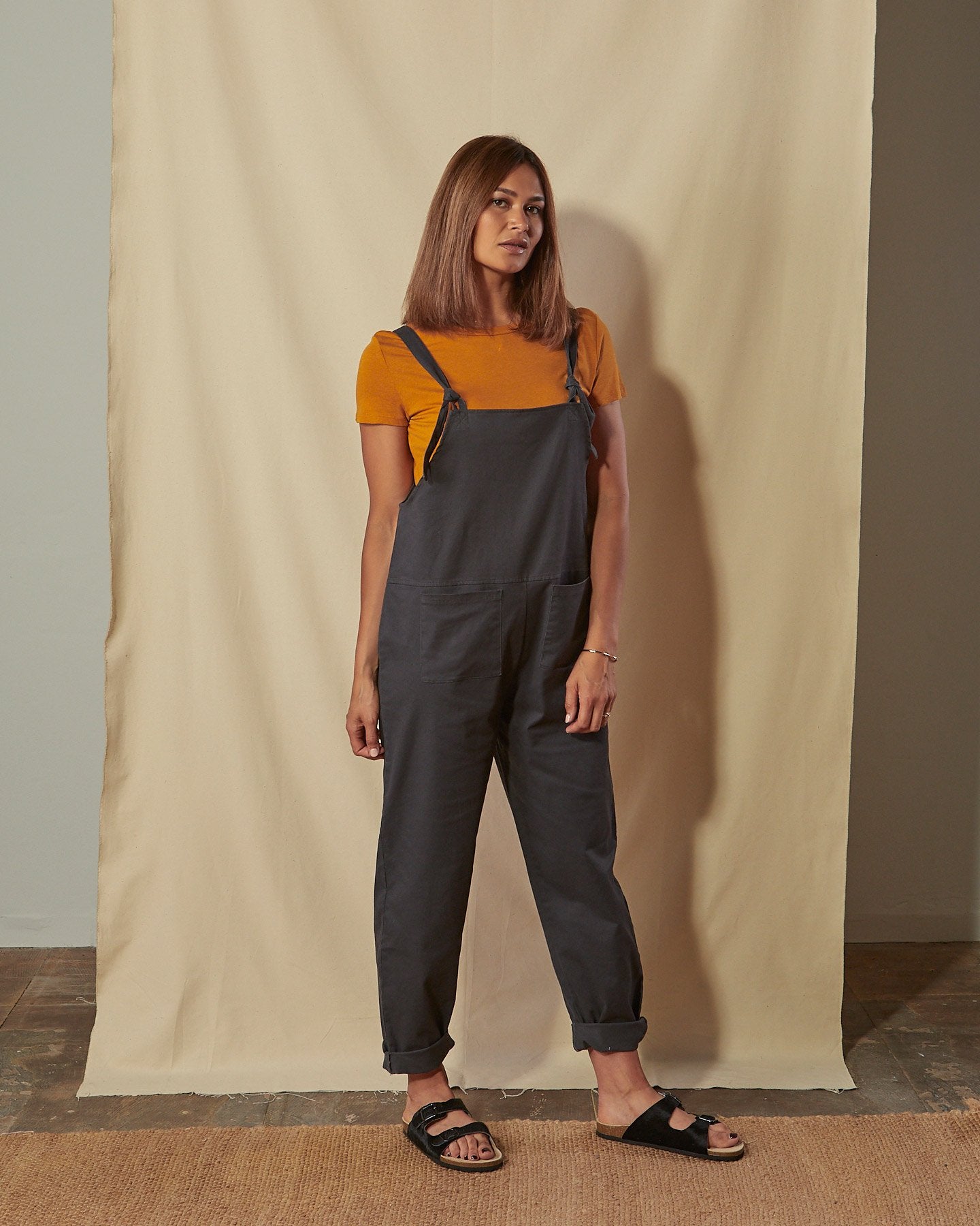 Full-length front view of Catherine dark grey cotton twill dungarees.