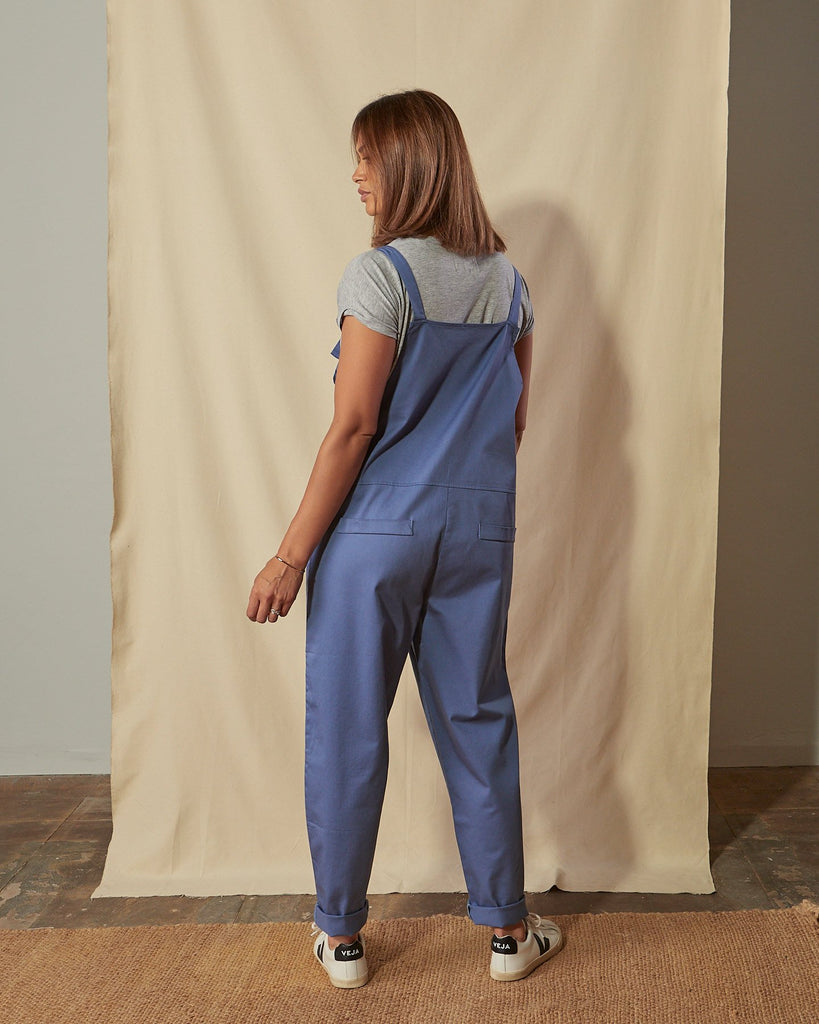 Full length back view of loose fit Catherine dungarees with clear view of the mock back pockets.