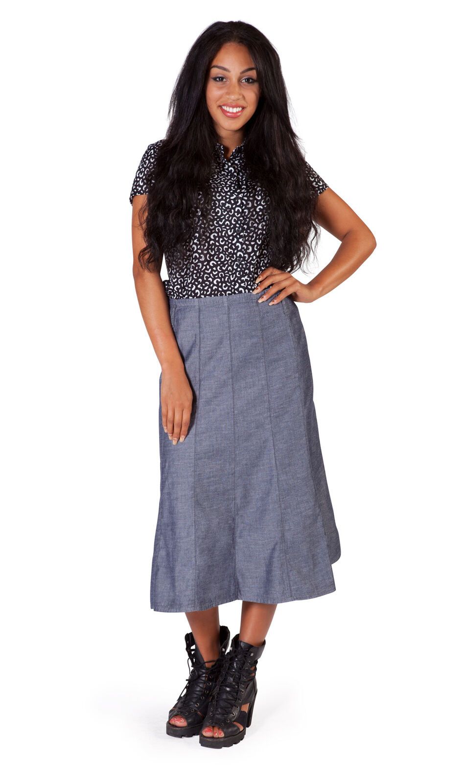 Full length front shot of calf-length dark chambray denim panelled skirt.