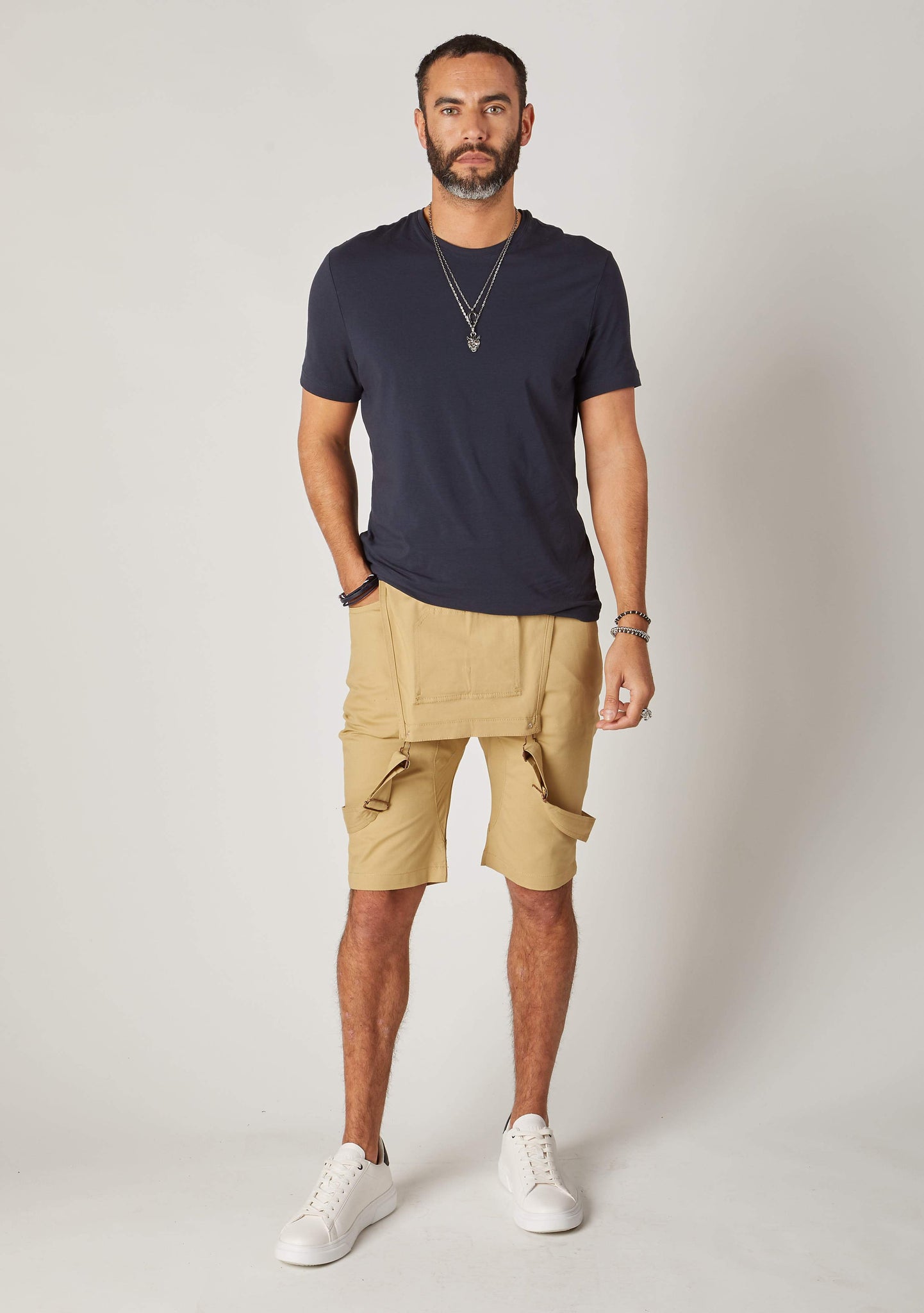 Full frontal bib-down view of slim-fit, khaki cotton bib-overall shorts from Dungarees Online, revealing dark grey t-shirt.