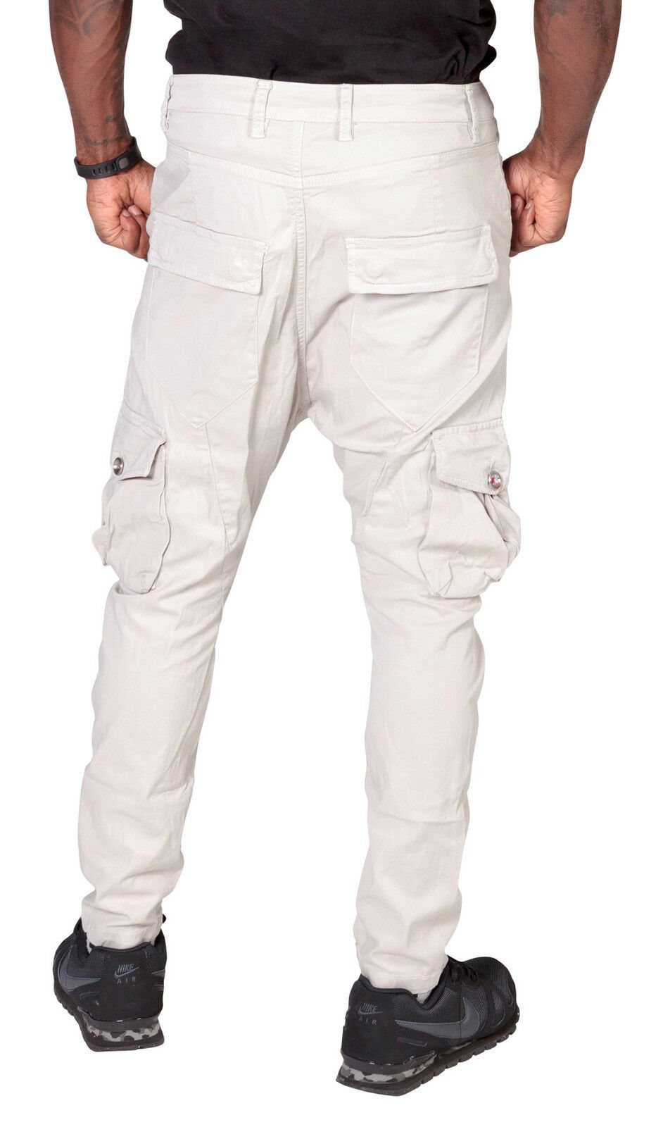 Close-up back view of ‘Finley’ style, casual cotton mix cargo trousers in stone, with view of multiple pockets, belt loops and tapered silhouette.