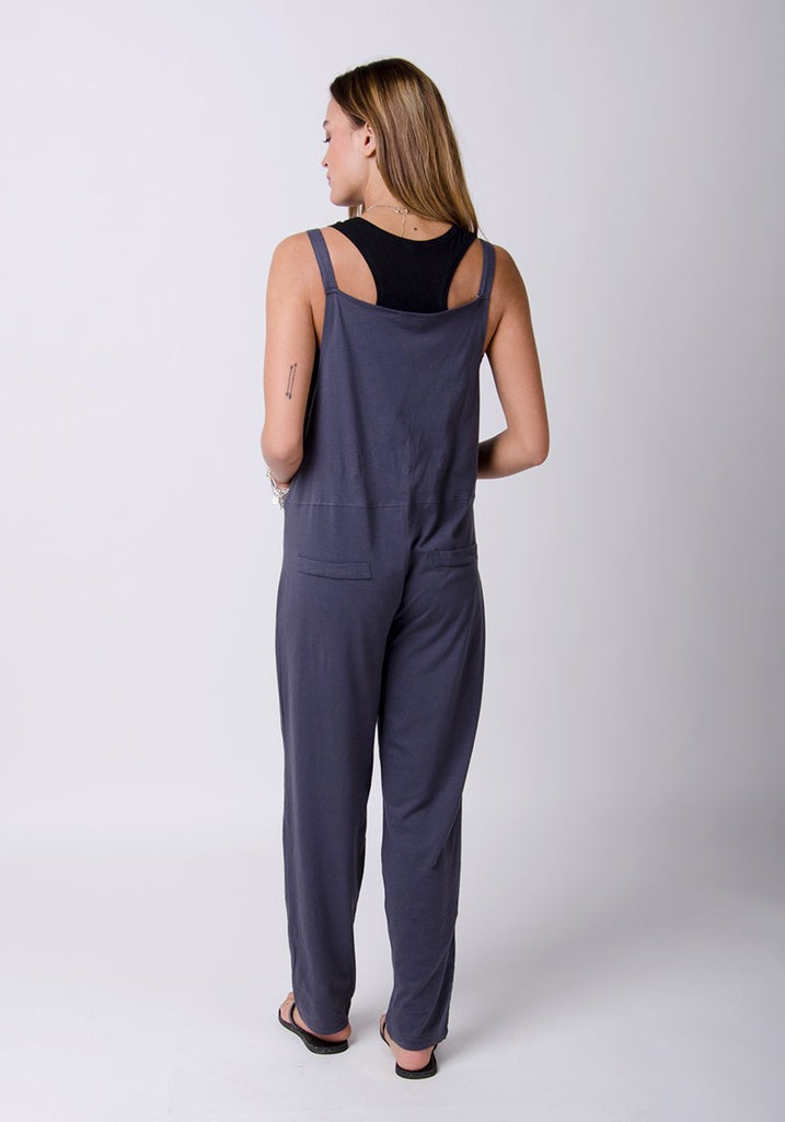 Full rear pose showing adjustable straps and back pockets.