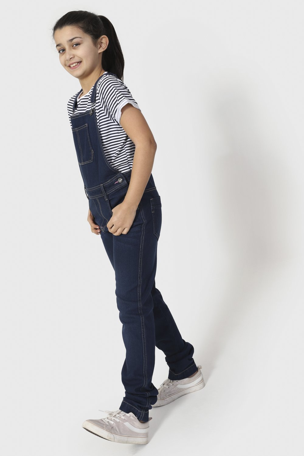 Full length front-side view of indigo denim, active girls, dungarees.