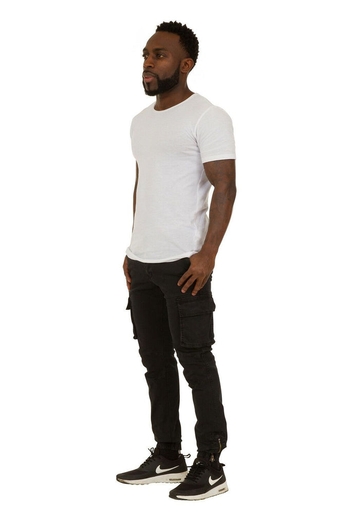 Full angled front-side view of black slight-stretch cotton mix combat trousers with view of cargo pockets and ankle zip.