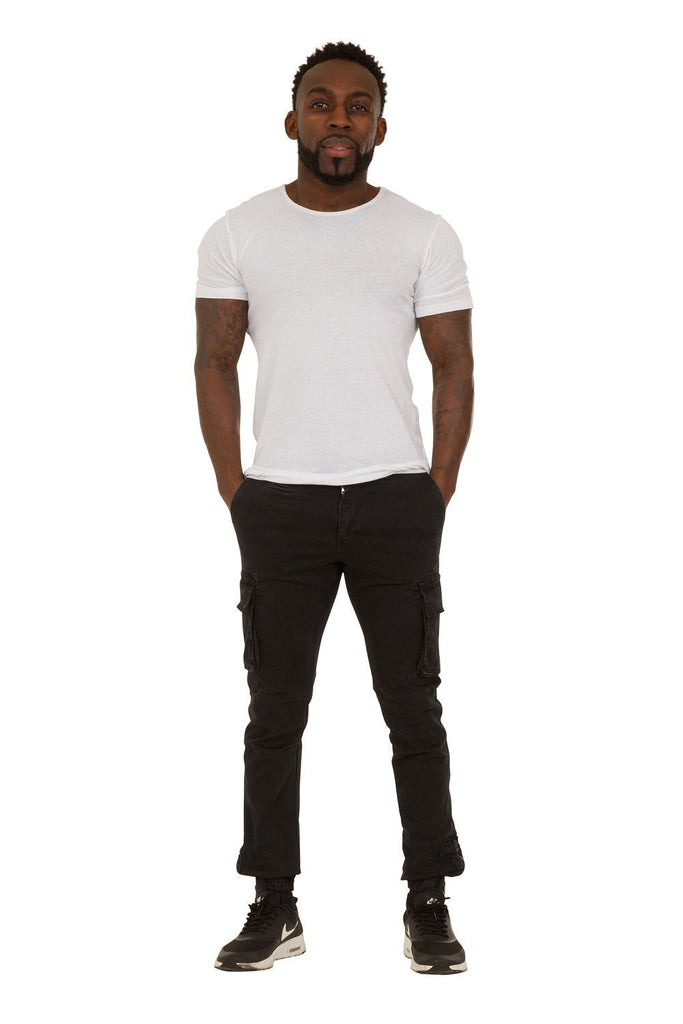 Full frontal view of ‘Jacob’ style, casual cotton mix cargo trousers in black with hands in front pockets.