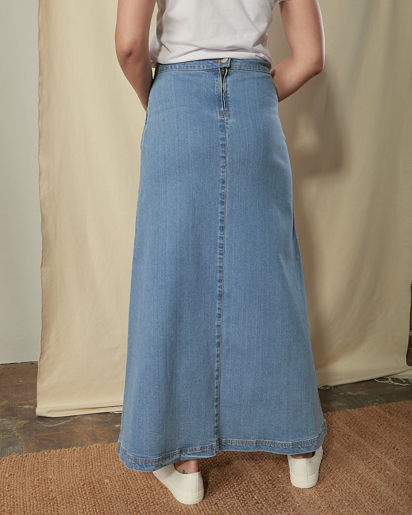 Two-thirds length back view of Jade A-line denim skirt showing ankle length hem with no back split.