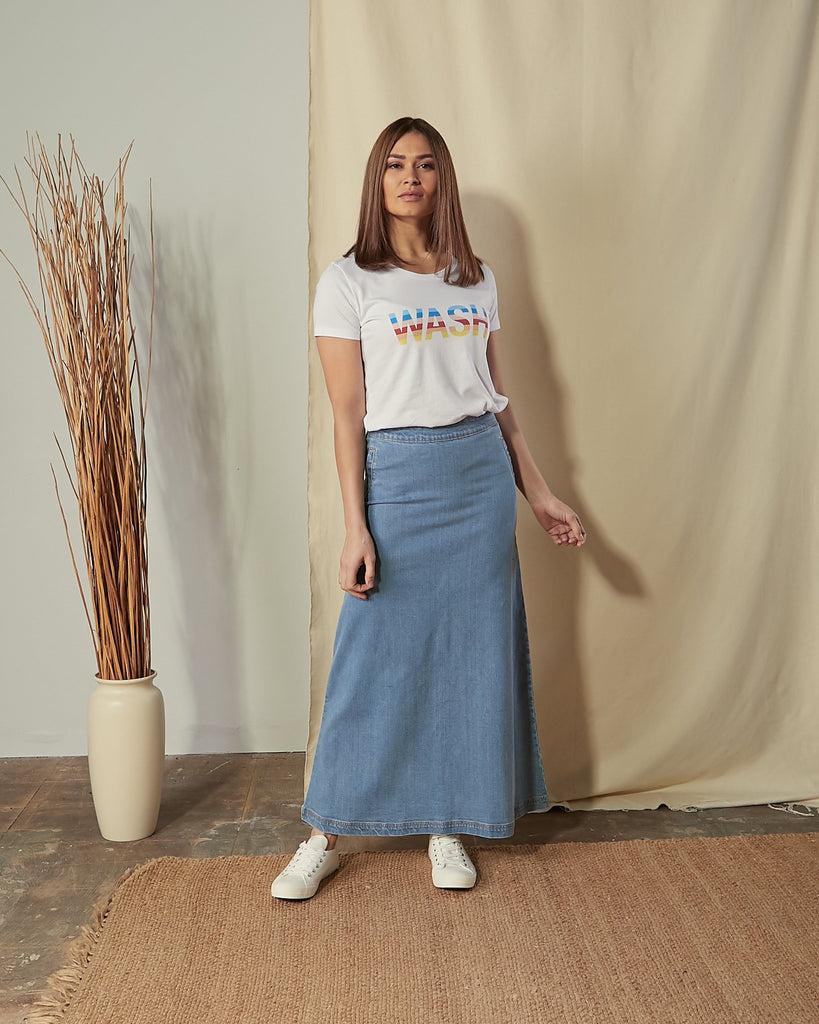 Full-length front view of model wearing Jade pale blue denim skirt.