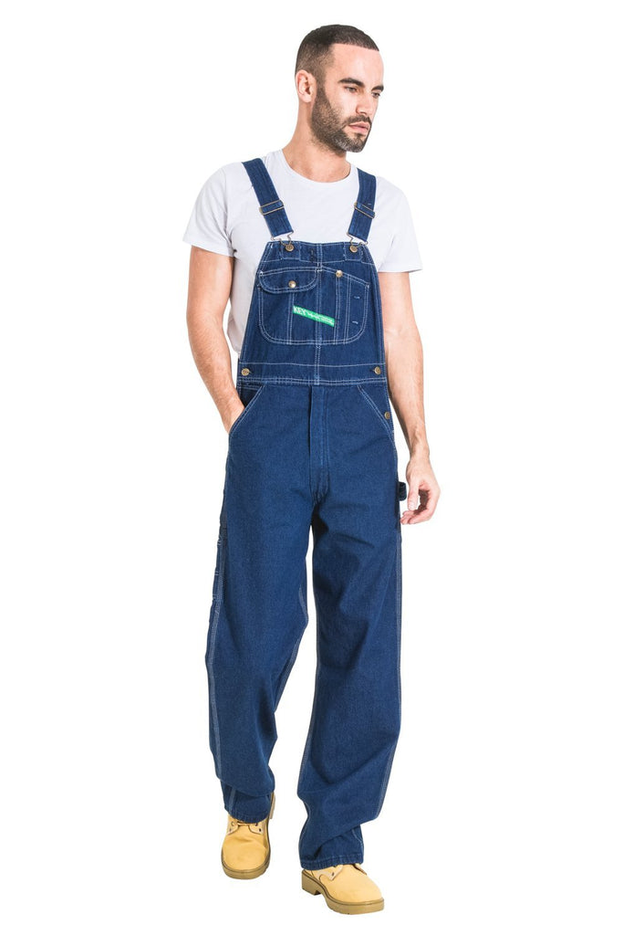 Full-length frontal view wearing relaxed-fit, indigo bib-overall made from premium materials and with superior finish.