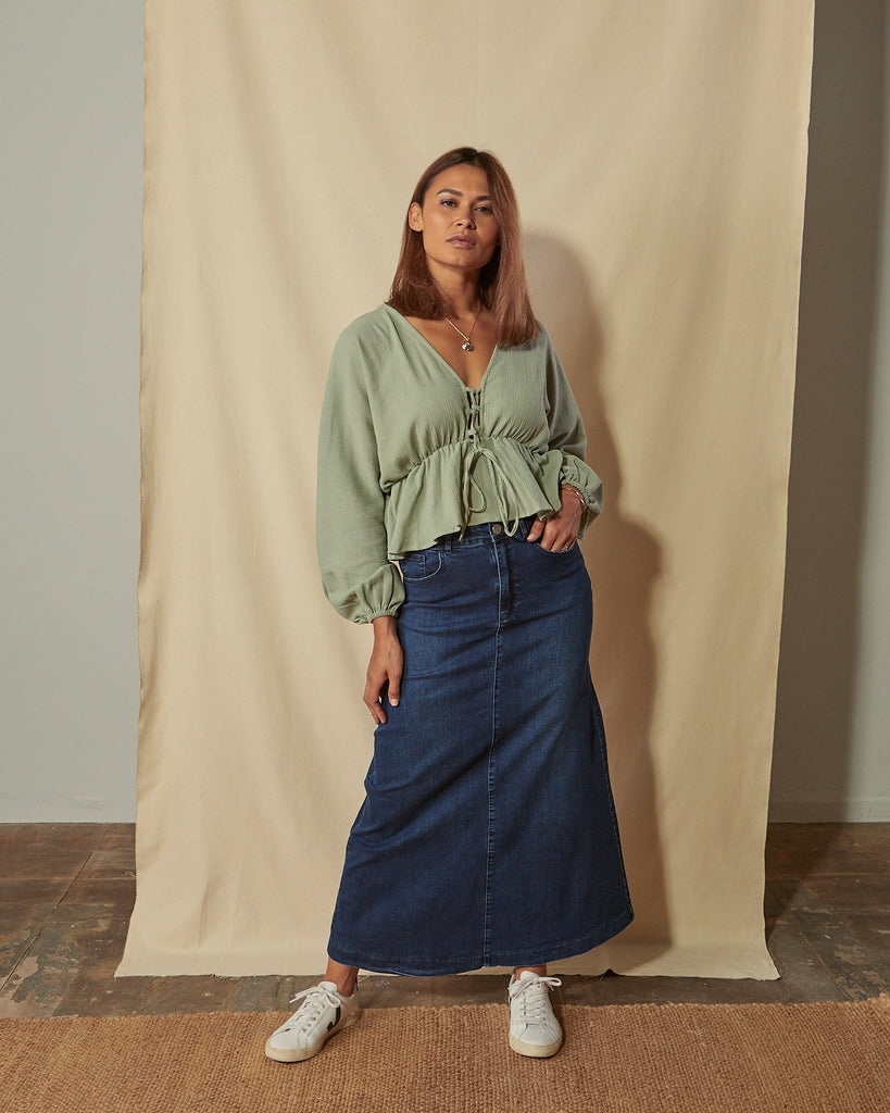Full-length front view of model wearing Kingsley flared long denim skirt with A-line silhouette and western styling.