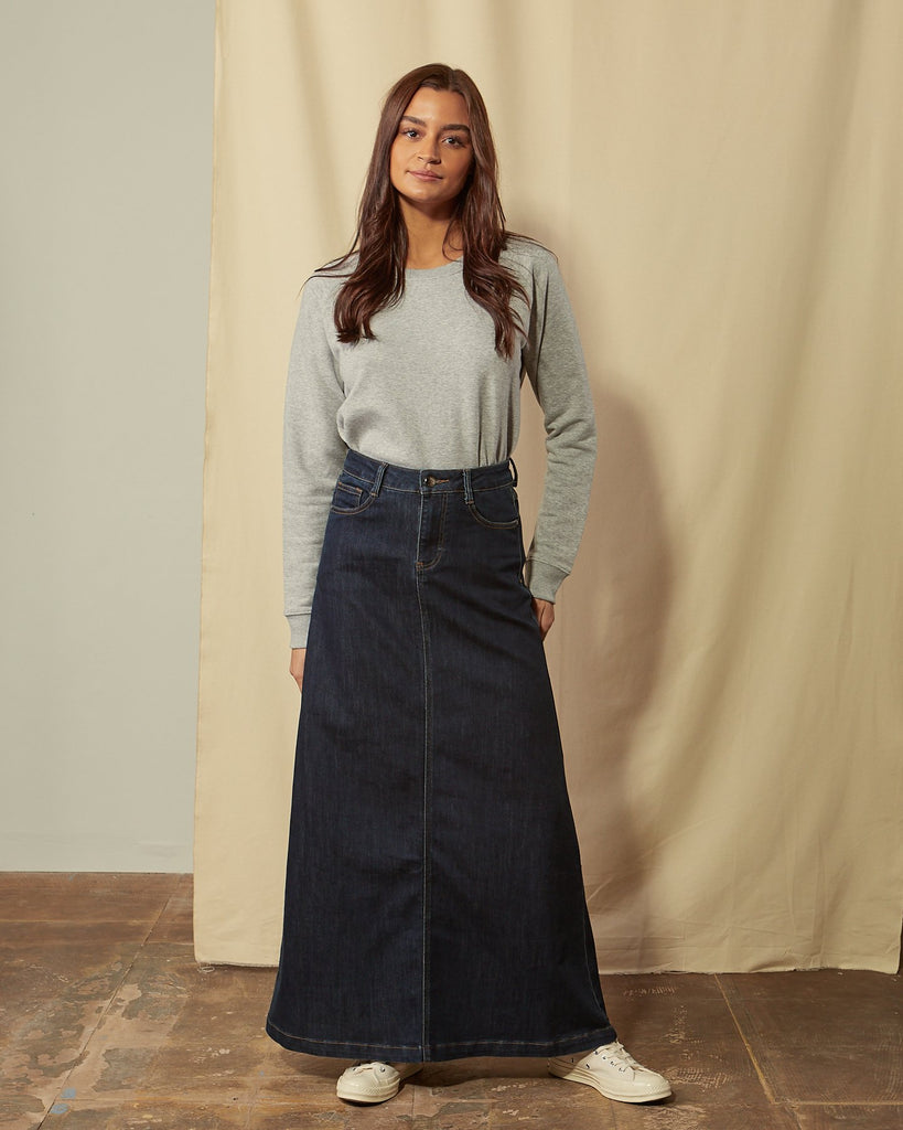 Full-length front view of dark blue denim skirt showing flared sillouette. 