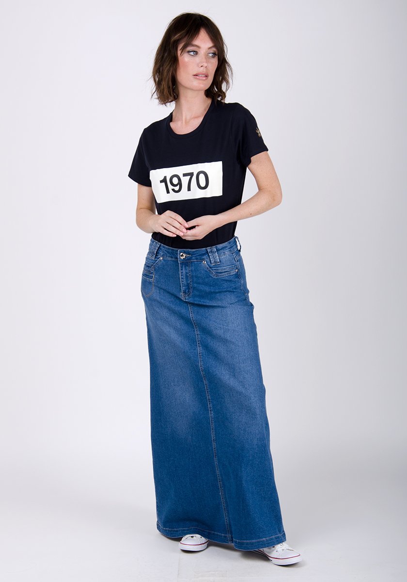Full-length front view of stonewash flared style denim skirt with clear view of front pockets, belt loops and button closure.