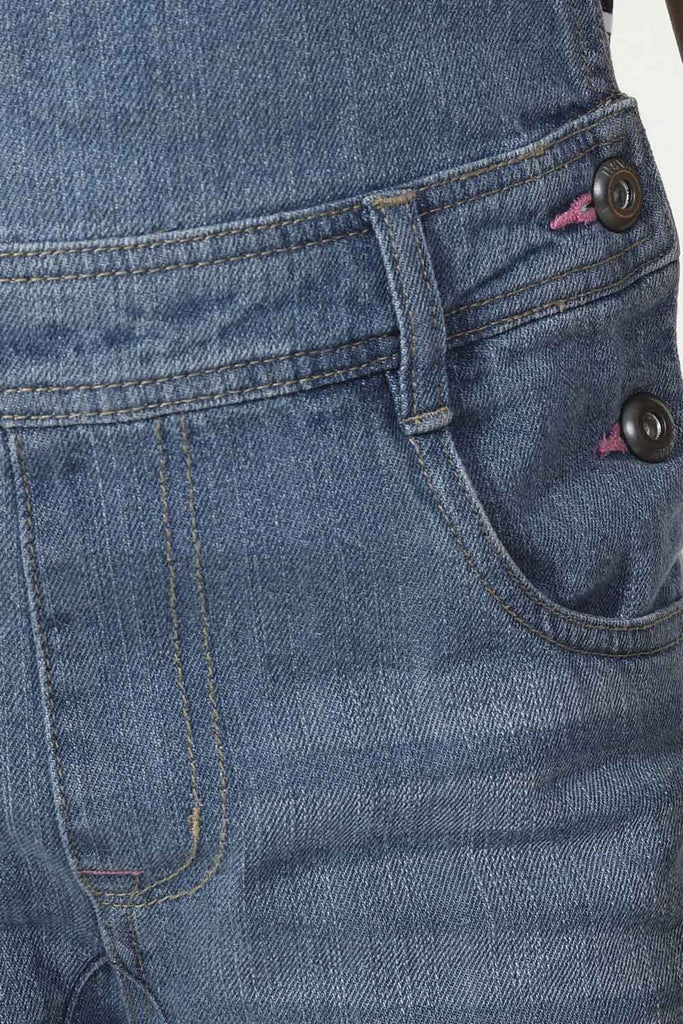 Close-up of front pockets, belt loops and button fastening with pink stitch detail.