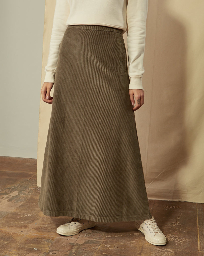 Close-up of Lottie olive-green corduroy full length skirt with clear view of cord fabric ridges.