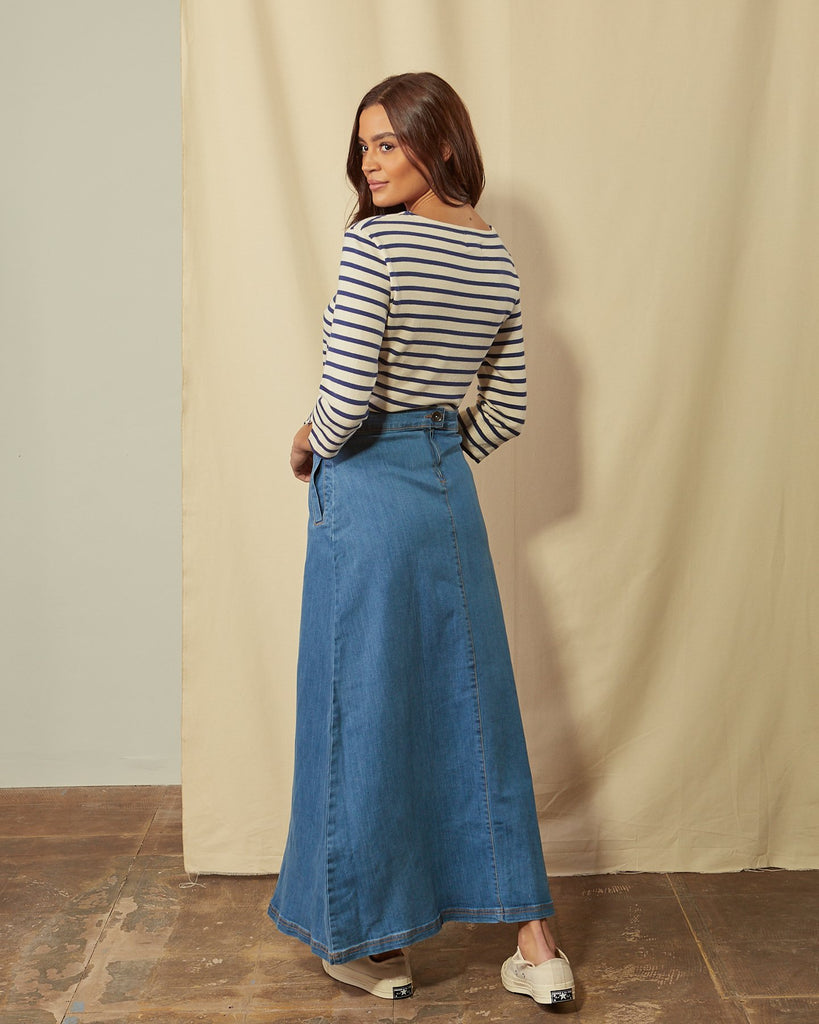 Full-length angled back view of Lottie palewash denim maxi-skirt showing back seam, zip and button.