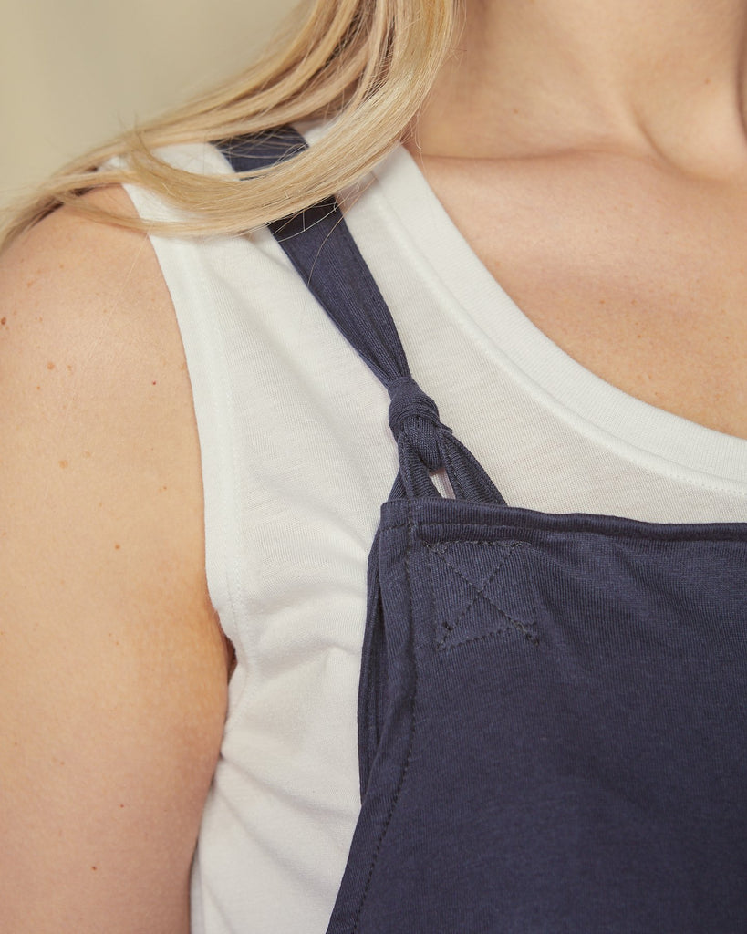 Close-up of cotton jersey navy Jumpsuit focusing on the tie shoulder straps.