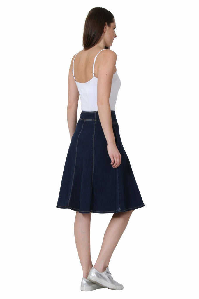 Full side view, facing right, wearing midi dark-indigo denim skirt.