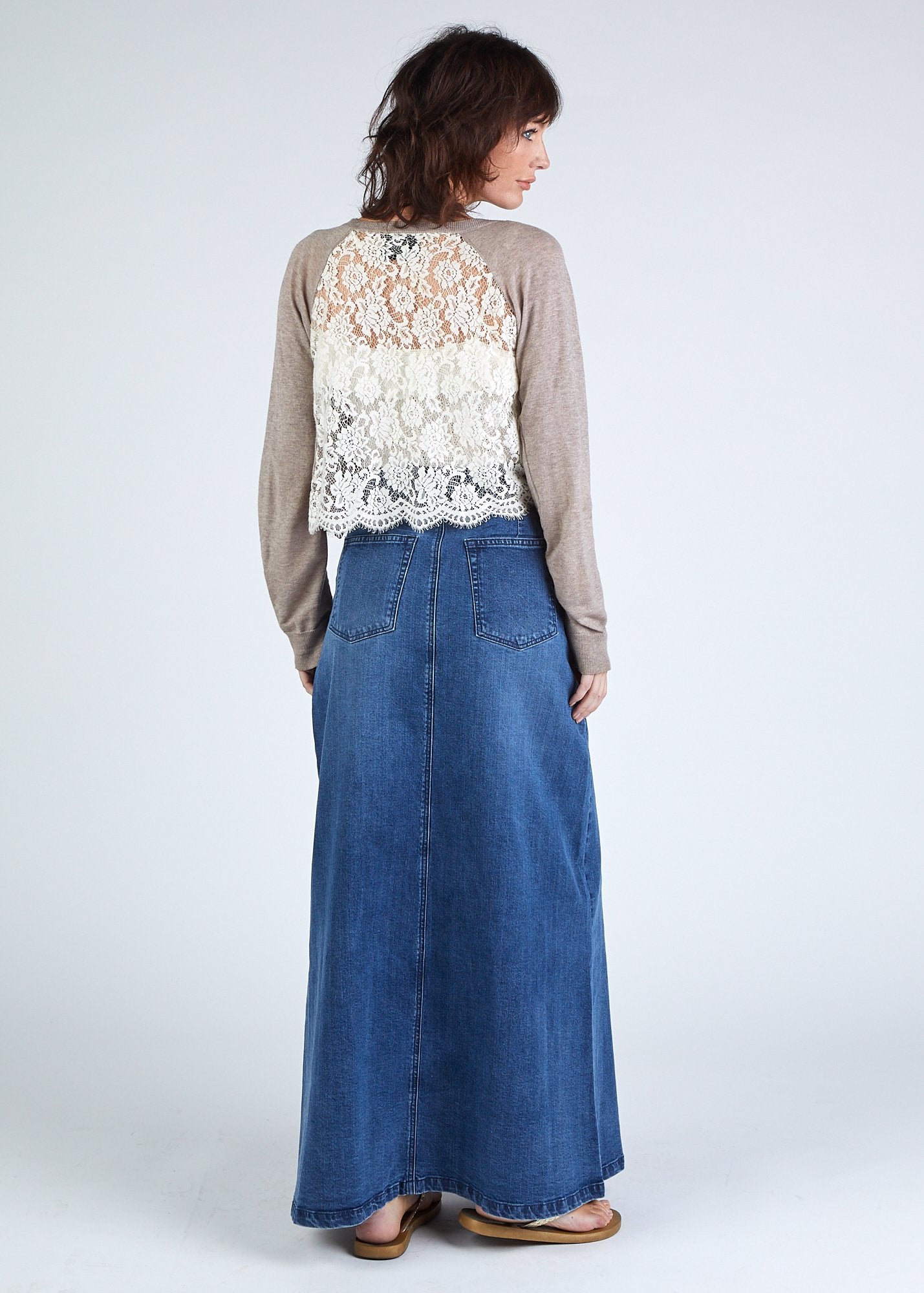 Full length rear view of organic cotton maxi denim skirt with view of back pockets and elegant silhouette.