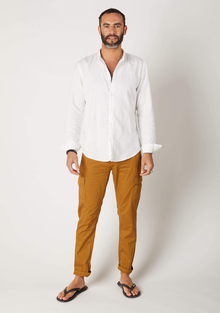 Full-length frontal pose wearing ‘Radcliffe’ style men’s dull-gold organic cotton slim fit cargo trousers.