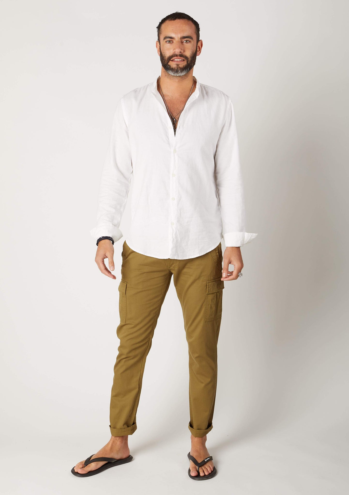 Full-length frontal pose wearing ‘Radcliffe’ style men’s olive organic cotton slim fit cargo trousers.