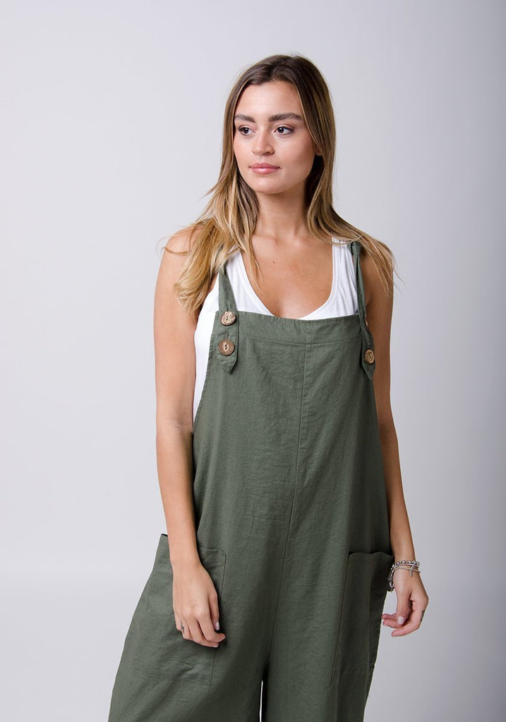 Two-thirds front-side view showing adjustable button straps of Saffy-style loose fit green overalls.