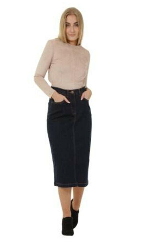 Full frontal with hands in front pockets of classic ‘Samantha’ denim midi skirt with stretch.