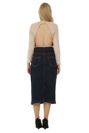 Full back view showing stretch of the denim and rear pockets of skirt, paired with backless fawn top.