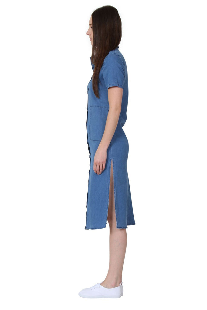Side view wearing button through midi denim dress with view of side split.