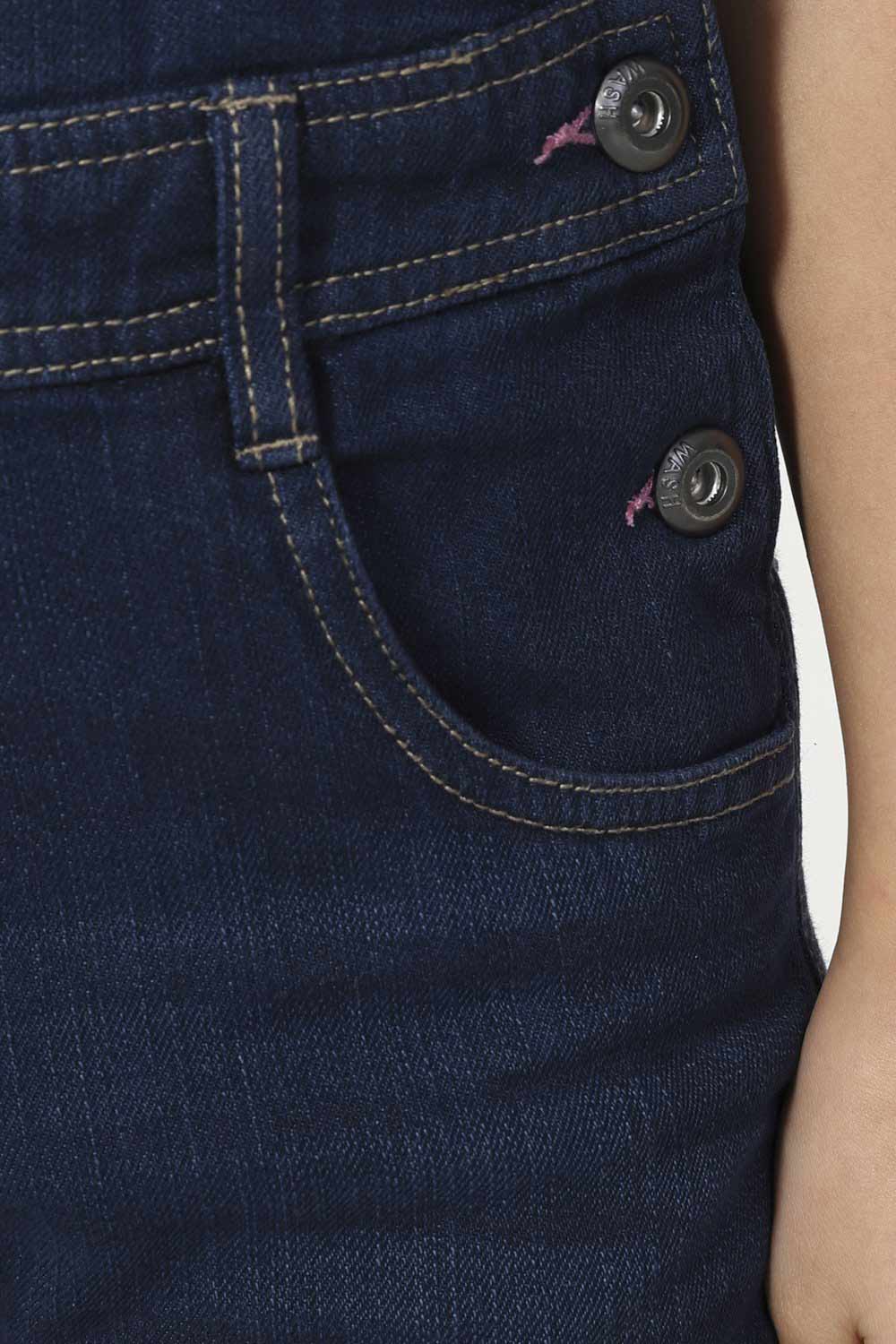 Close-up of front pockets and button fastening with pink stitch detail.